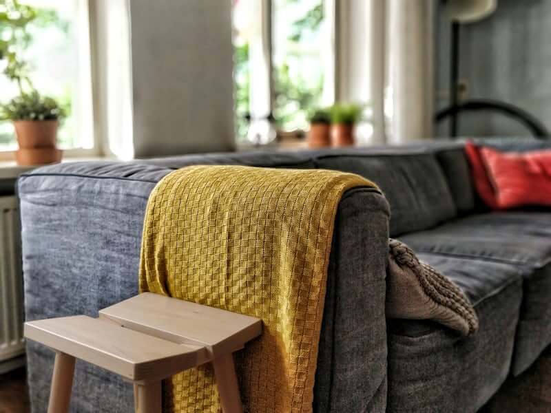 Layered textiles and pillows on a budget-friendly sofa