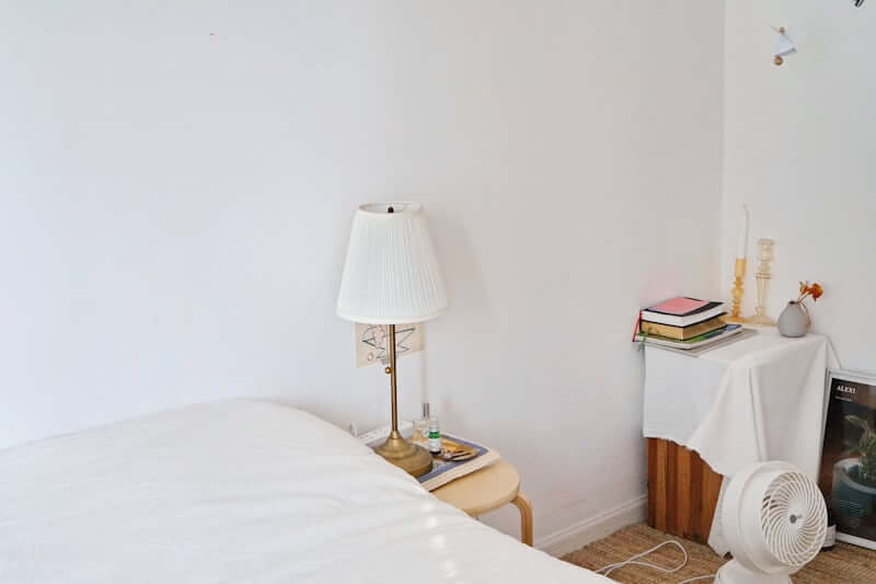Minimal nightstand styling in a warm neutral bedroom
