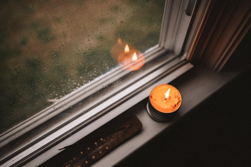 Styled window sill with small plant and candle in a cozy room