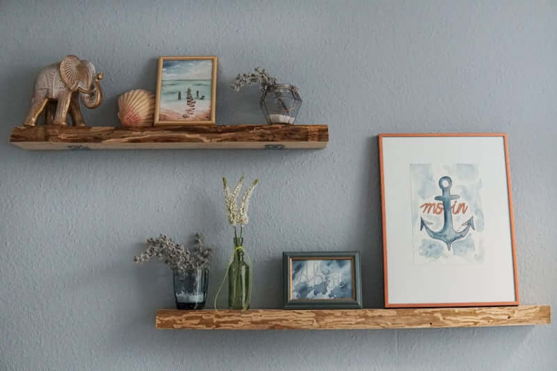 Large vase anchoring a styled shelf vignette