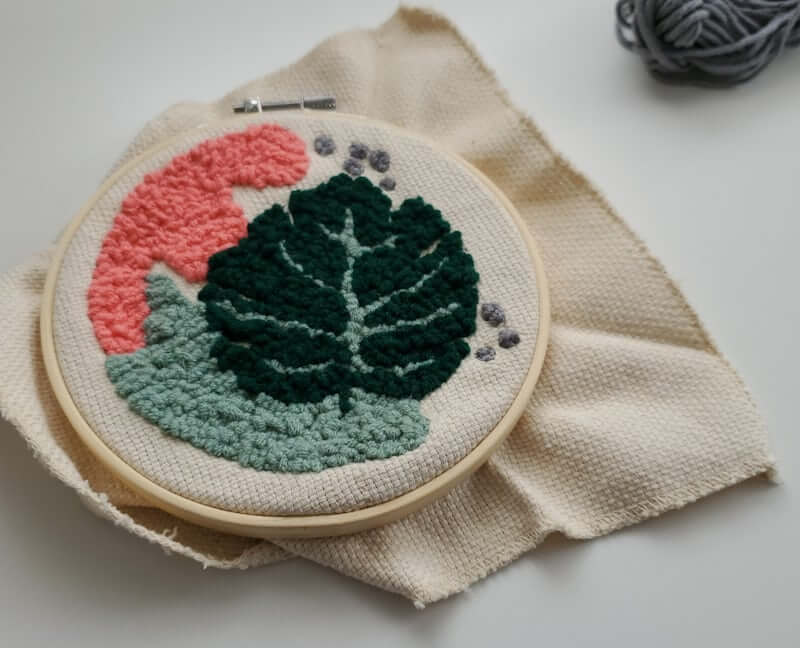 thread-painted leaf motif in a small embroidery hoop