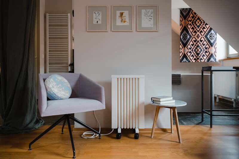 Small cozy reading corner with armchair near a bedroom window