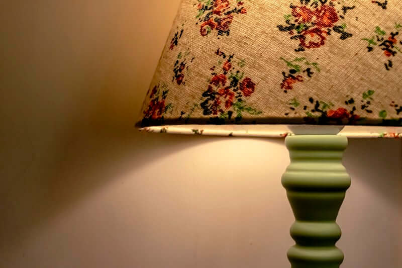 Warm LED string lights tucked behind a headboard for ambiance