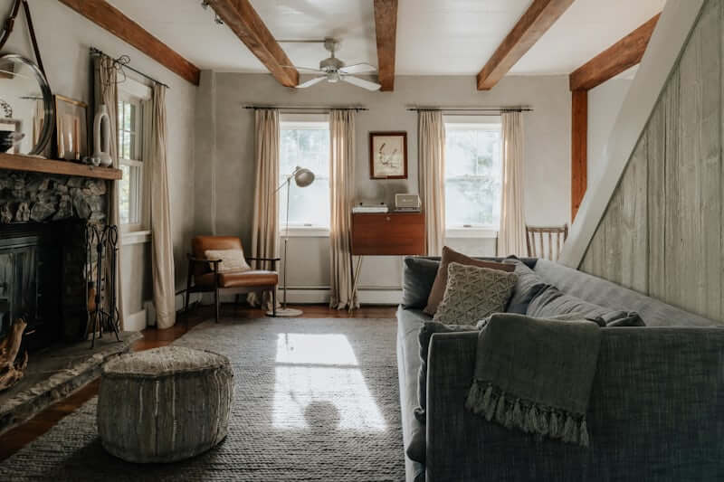 Large wicker basket with folded blankets beside a sofa