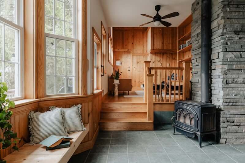 Cozy reading nook styled with a chair, lamp, and throw blanket