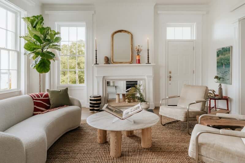 Living room with curved sofa and round wooden coffee table