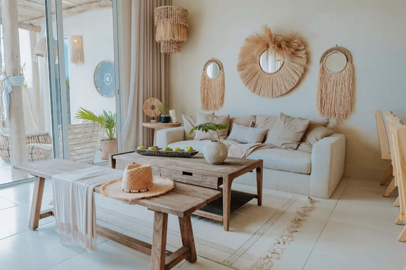 Large round mirror with rattan frame in a warm living room]