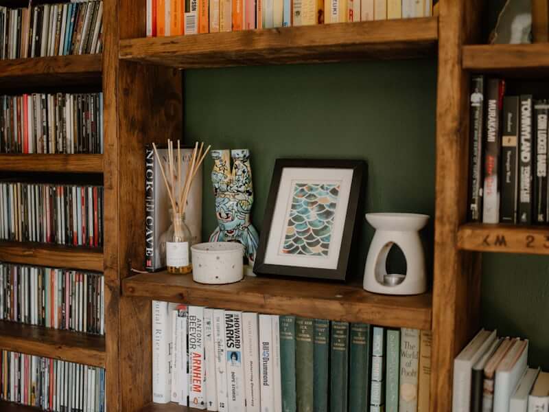 Close-up of personal shelf with meaningful objects, books, and a plant
