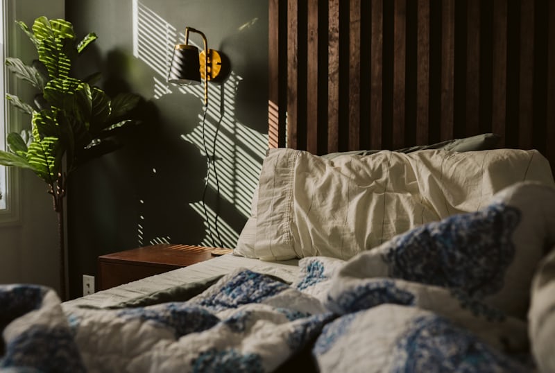 Finished budget bedroom glowing with warm, cozy light