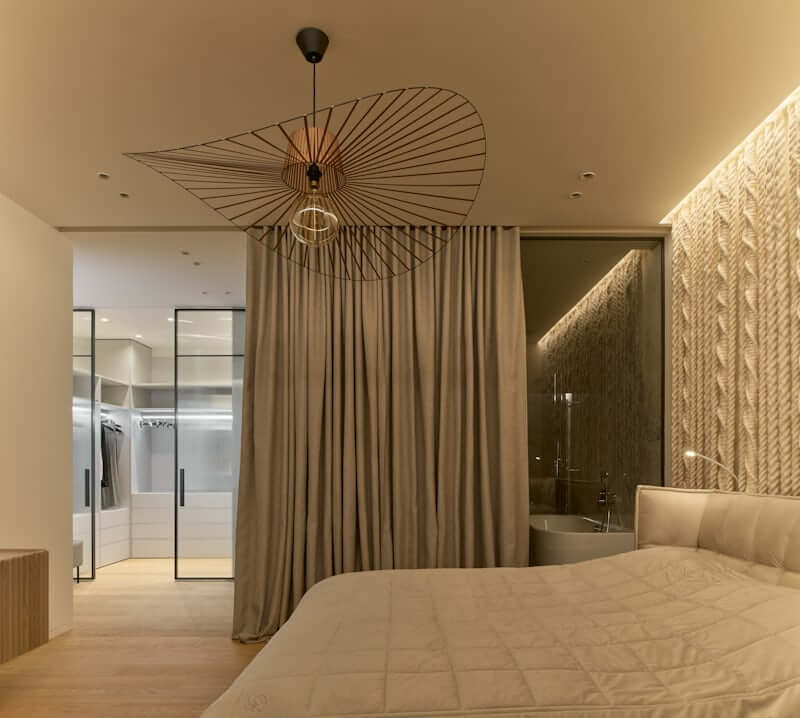 Curtain panel used as a soft room divider in a small apartment