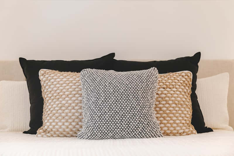 felt shapes stitched onto a neutral throw pillow