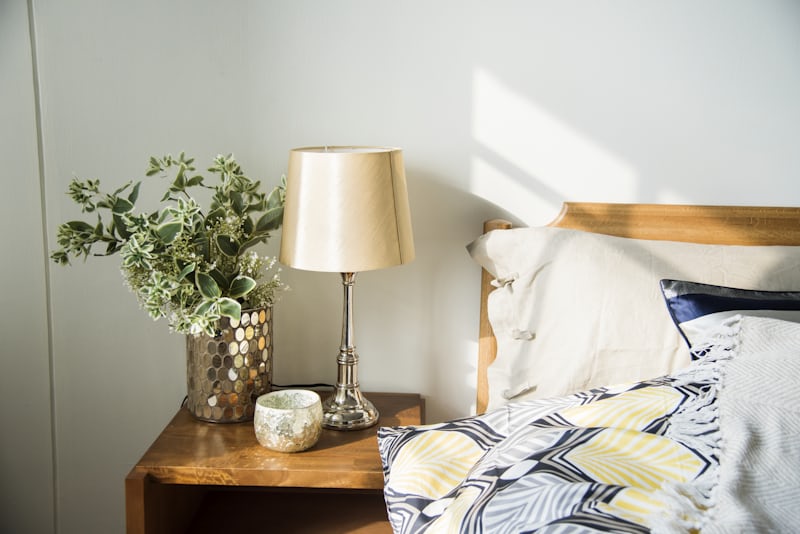 Linen shade lamp on a bedroom nightstand for warm lighting