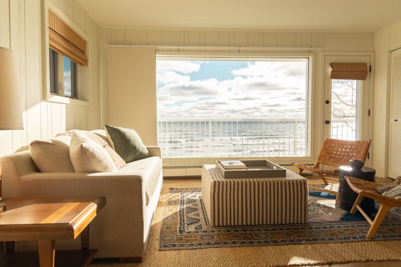 Coastal living room with large window and natural light airy decor