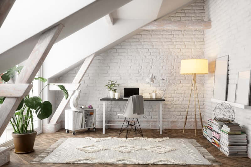 Rug used to define a seating zone in an open studio apartment